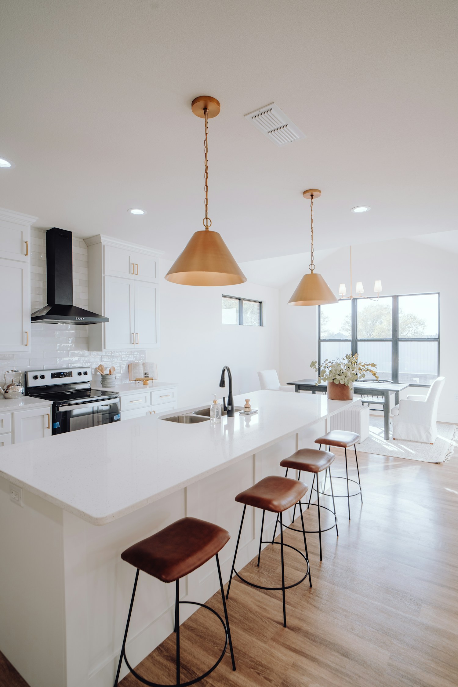A large kitchen with a central island and stools