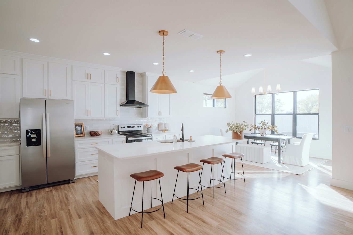 A kitchen with a large island and seating stools