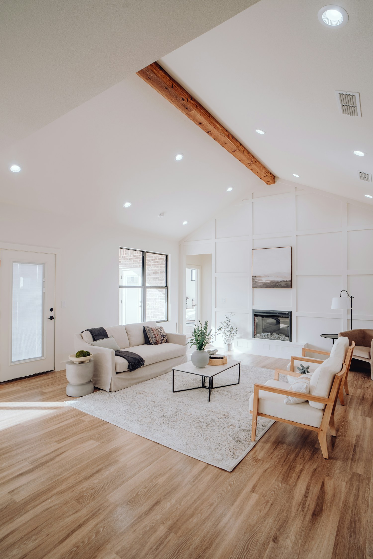 A living room and kitchen with an island and fireplace