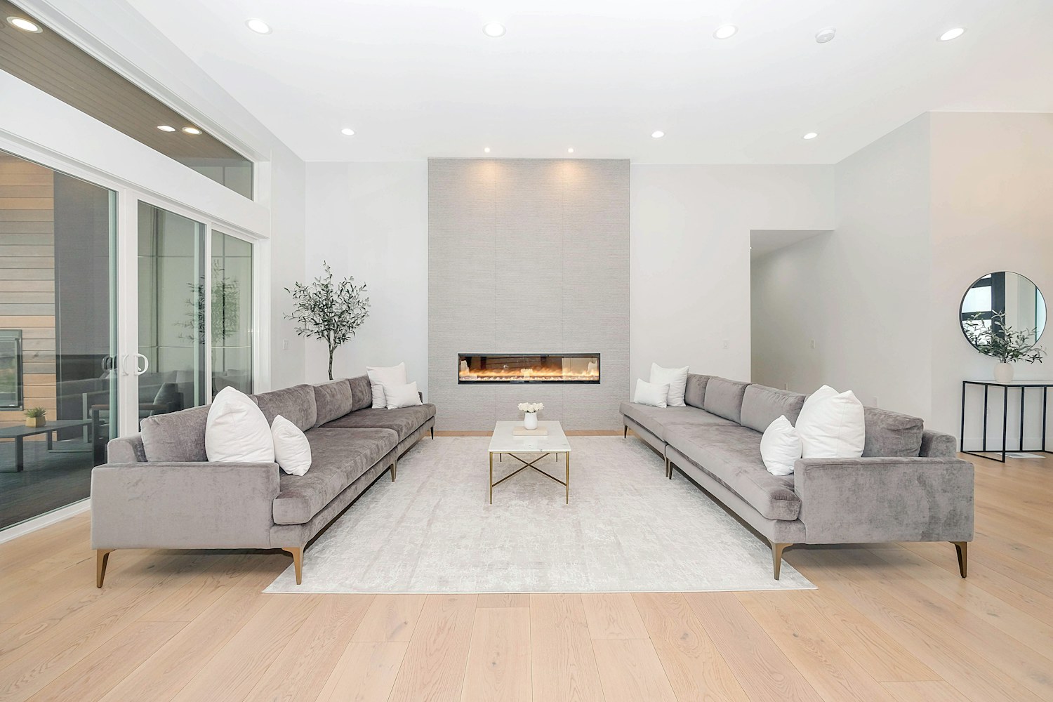Two gray sofas facing each other in a bright living room