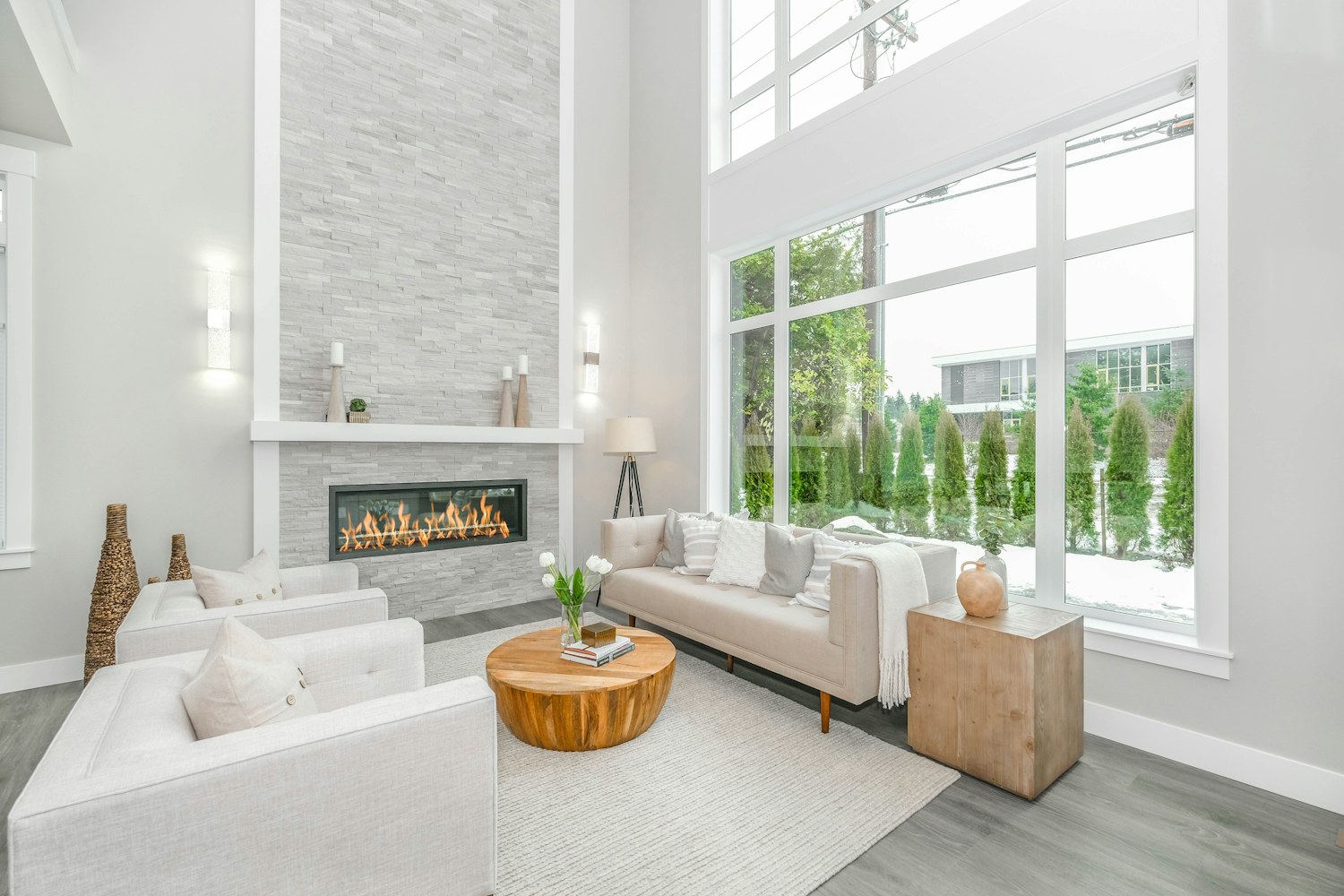 A white couch near a large glass window