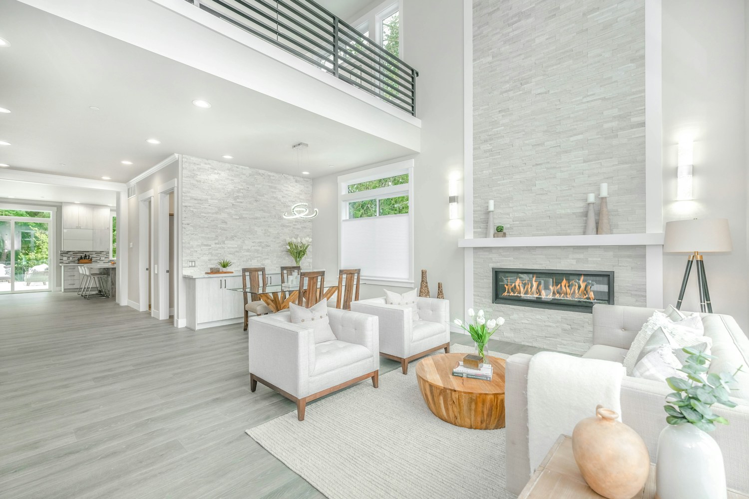 A living room with a white and brown seating arrangement