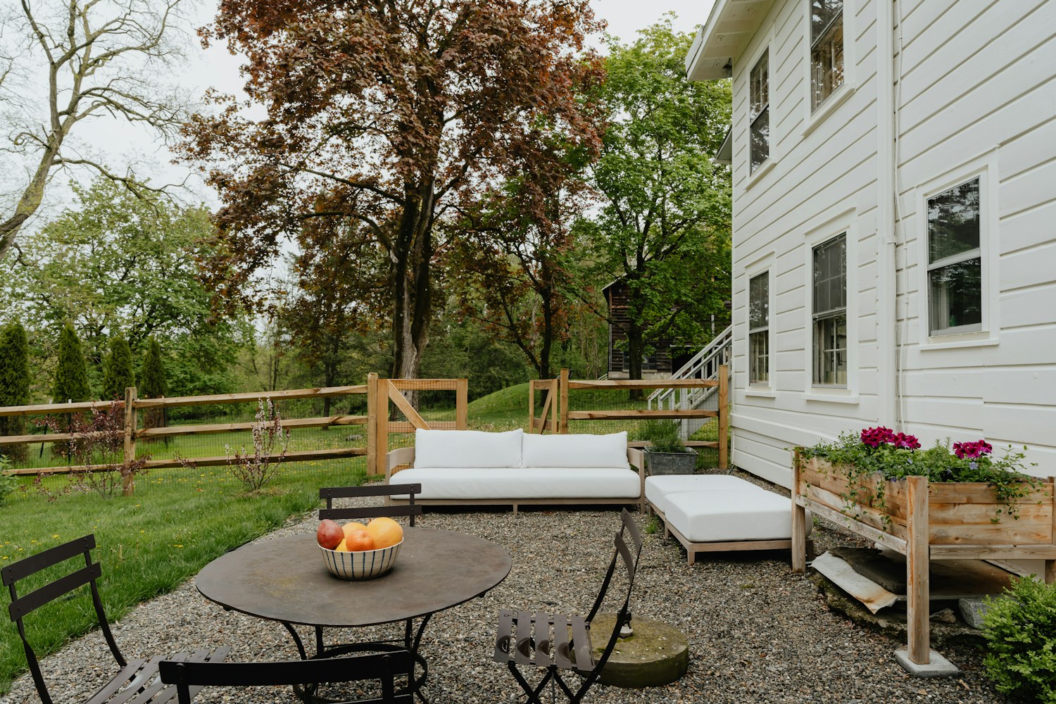 A patio arranged with a table, chairs, and lounge seating