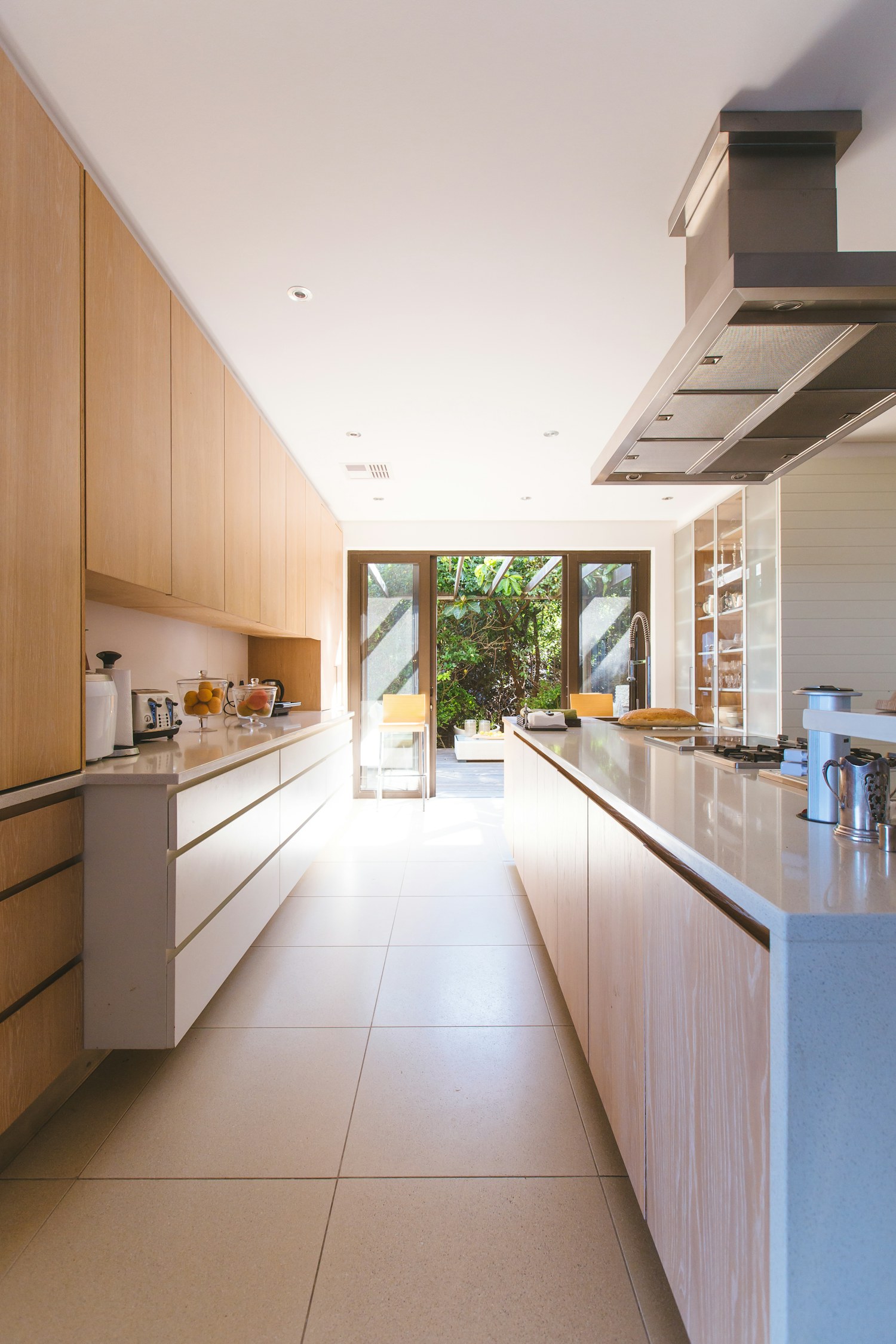 A light-filled kitchen with a white island and cabinets