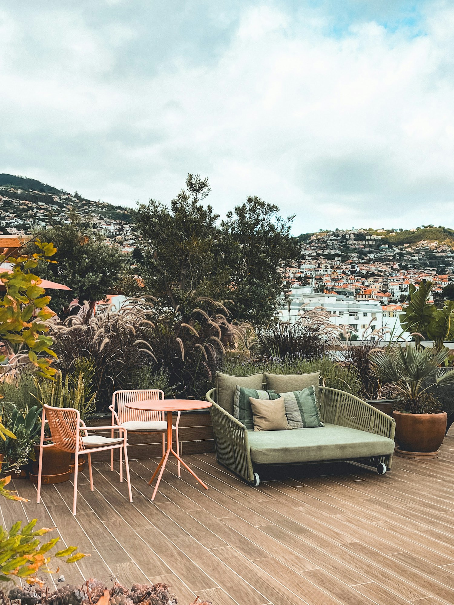 A patio arranged with a couch, table, and chairs
